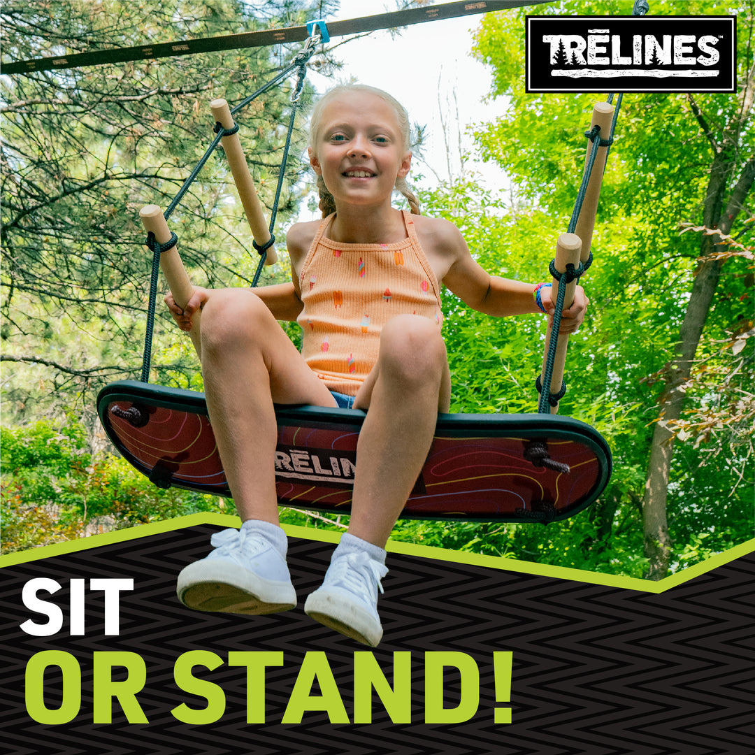 Child sitting on a surf swing set with trees in the background