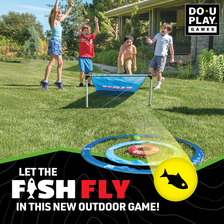 Children playing Fish Fly outdoor game with blue target, yellow ball, and grassy backyard setting near house