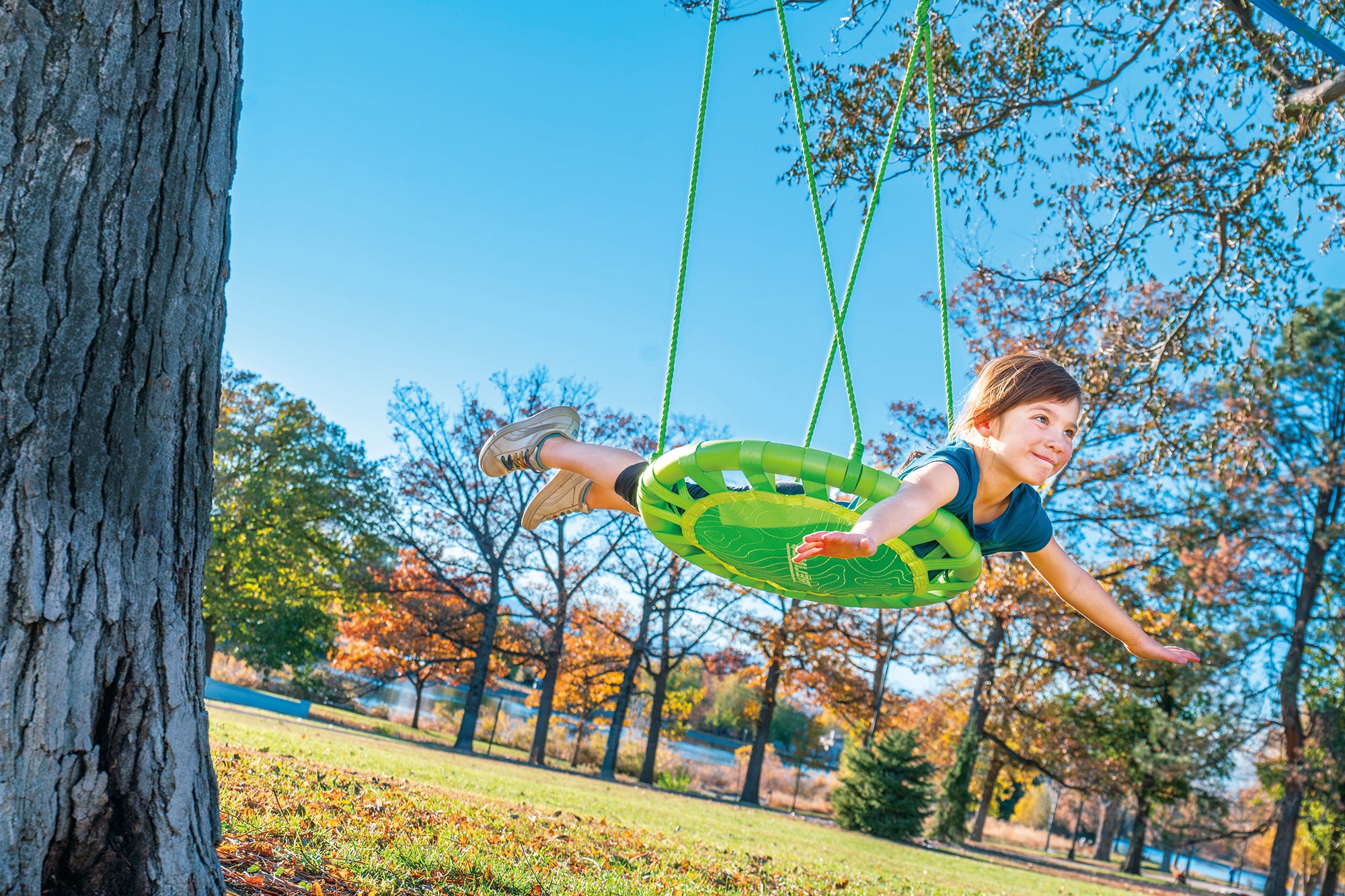 kid on explorer tree swing on slackline