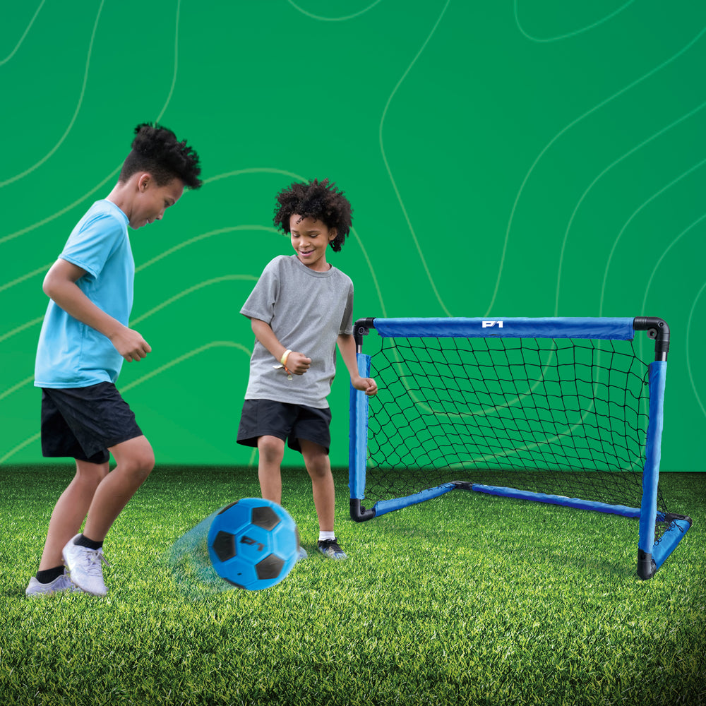 Two children playing with a P1 soccer ball and training goal 