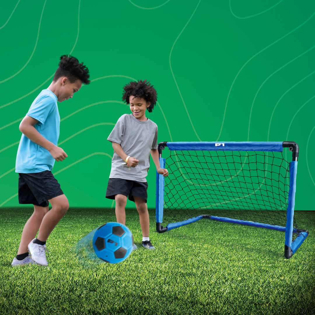 Two children playing with a P1 soccer ball and training goal 