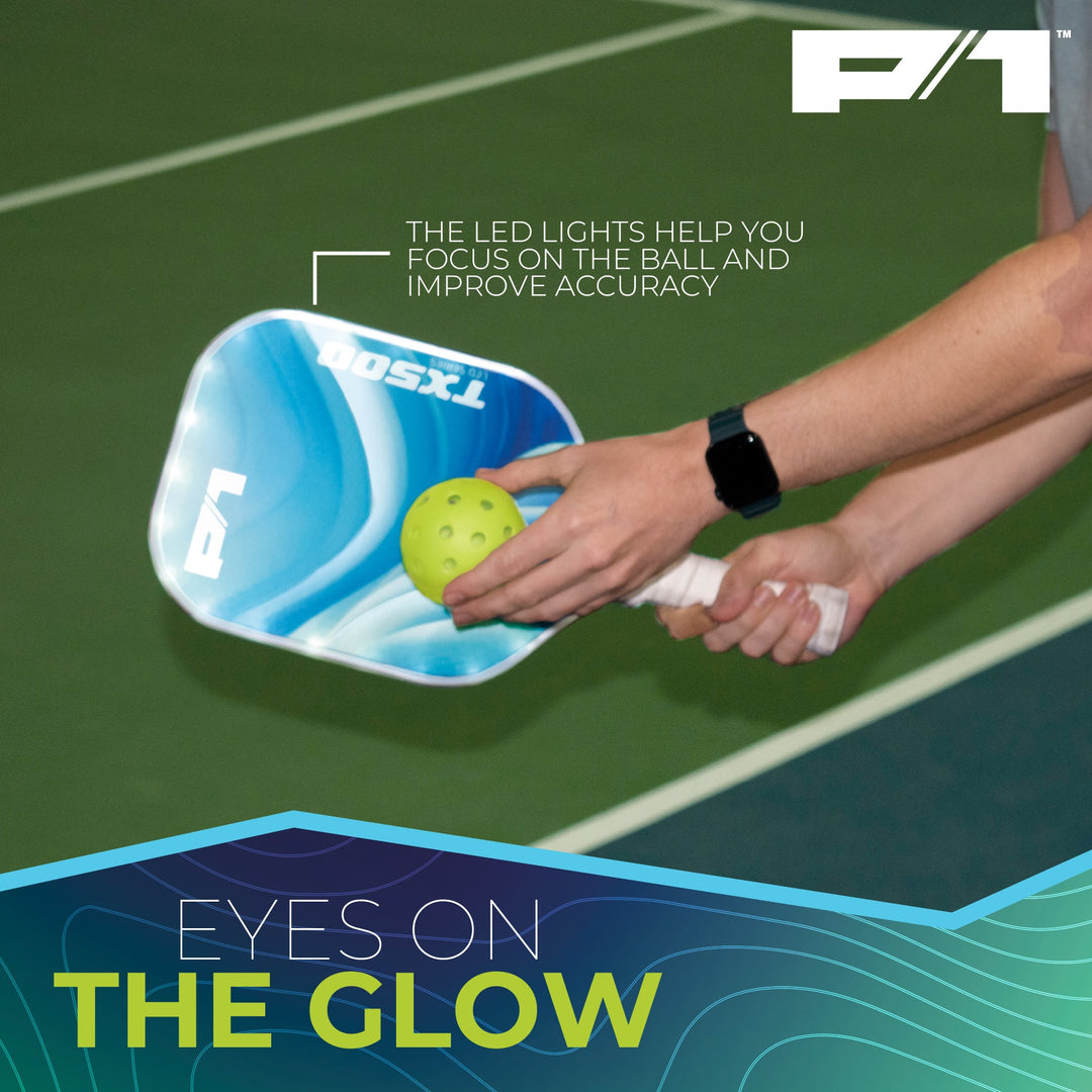 Nighttime pickleball match with glowing paddles and ball in play