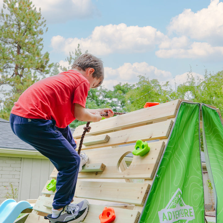 Child climbing obstacle on the wall in the playhouse